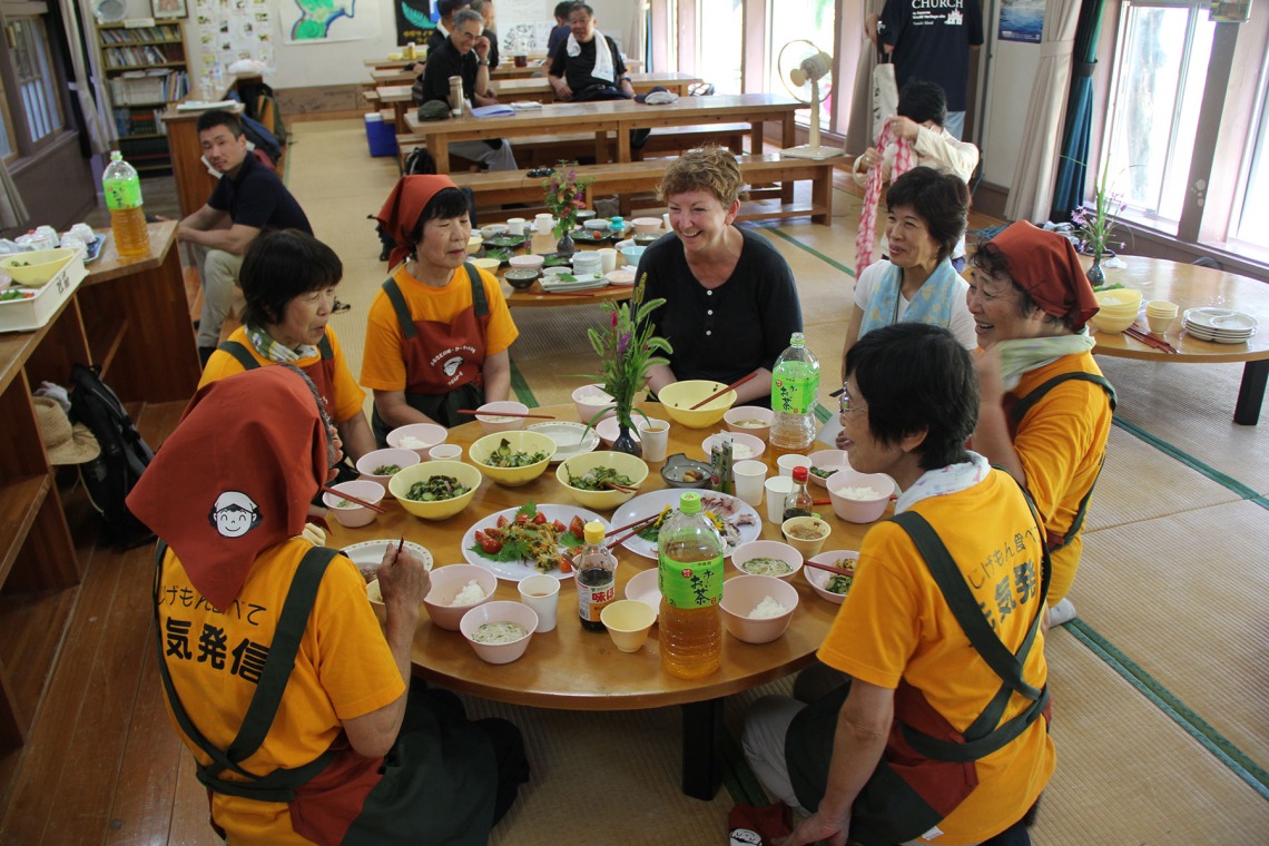 Pollock-Ellwand shares a meal with women from a Japanese village during a UNESCO visit in 2017.