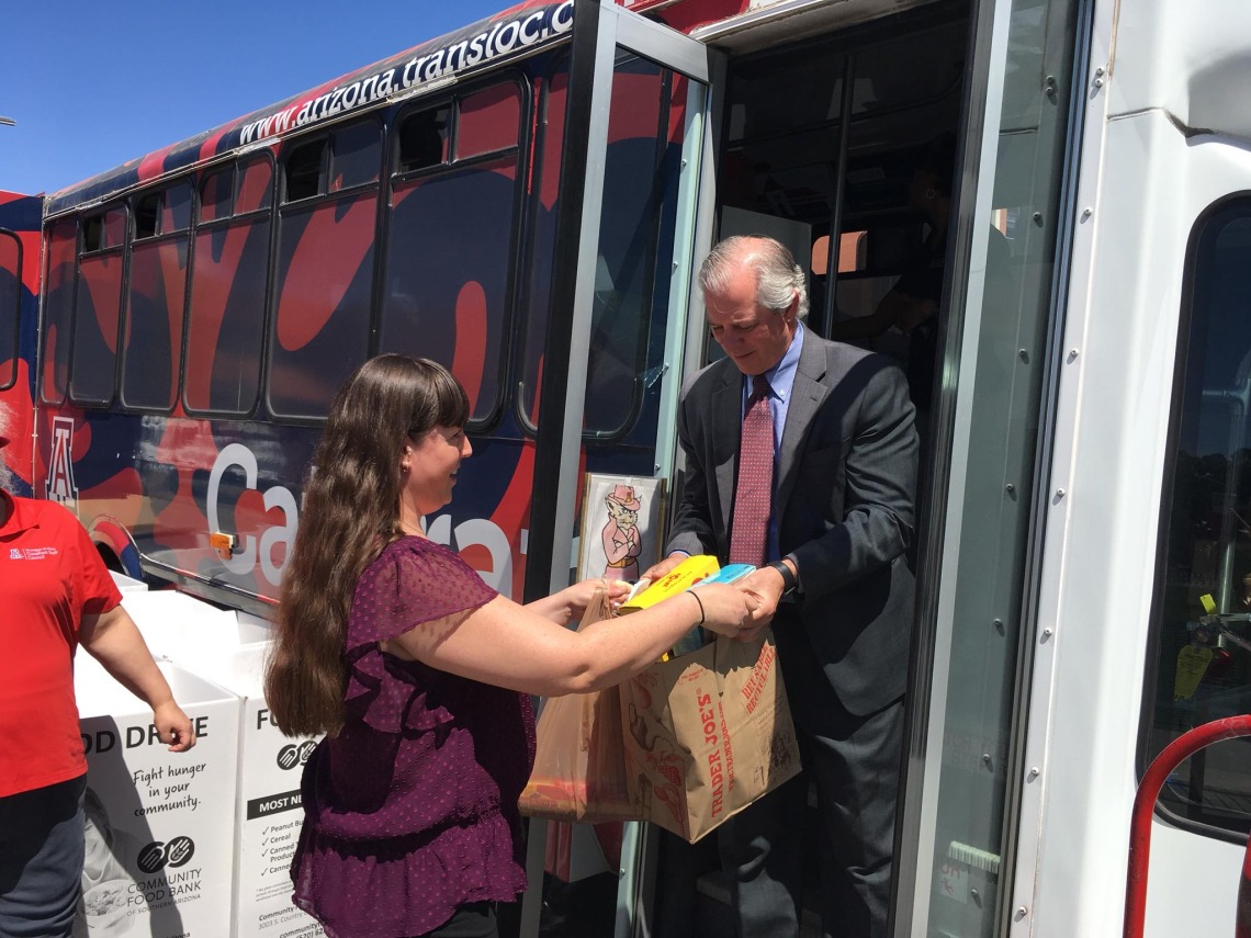 UA President Robert C. Robbins collects a box of food during a previous Stuff the Cat Tran. This year's event will run 7 a.m. to 6 p.m. on April 8.