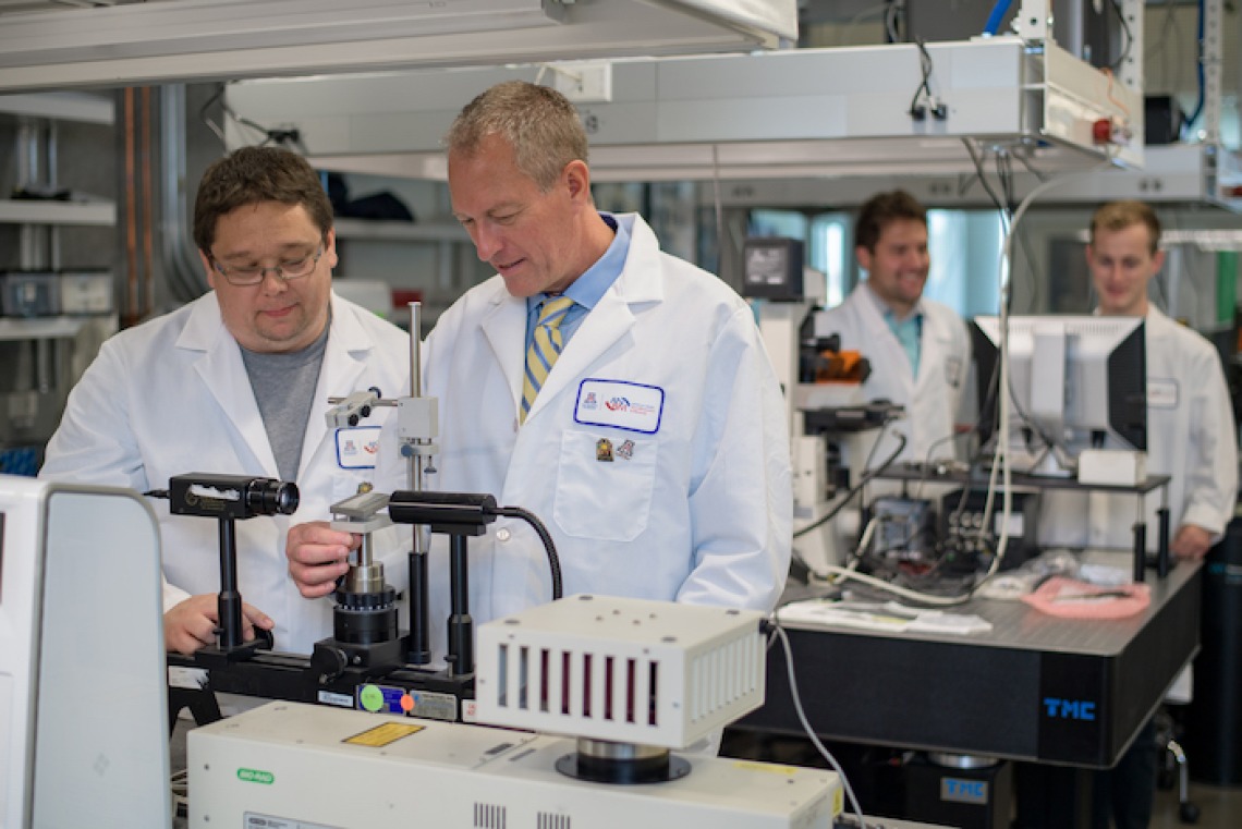 Frederic Zenhausern, right, professor and director of the Center for Applied NanoBioscience and Medicine, works in his lab with Matthew Barrett, a senior research specialist. (Photo courtesy of the College of Medicine – Phoenix)